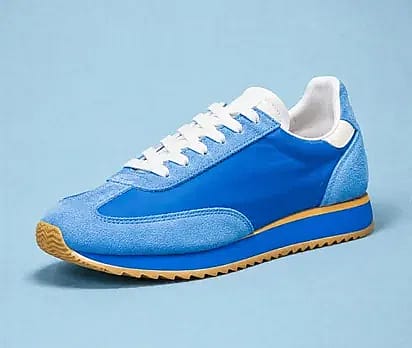 Blue suede running shoe on a blue backdrop