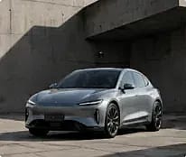 Silver car against a concrete wall