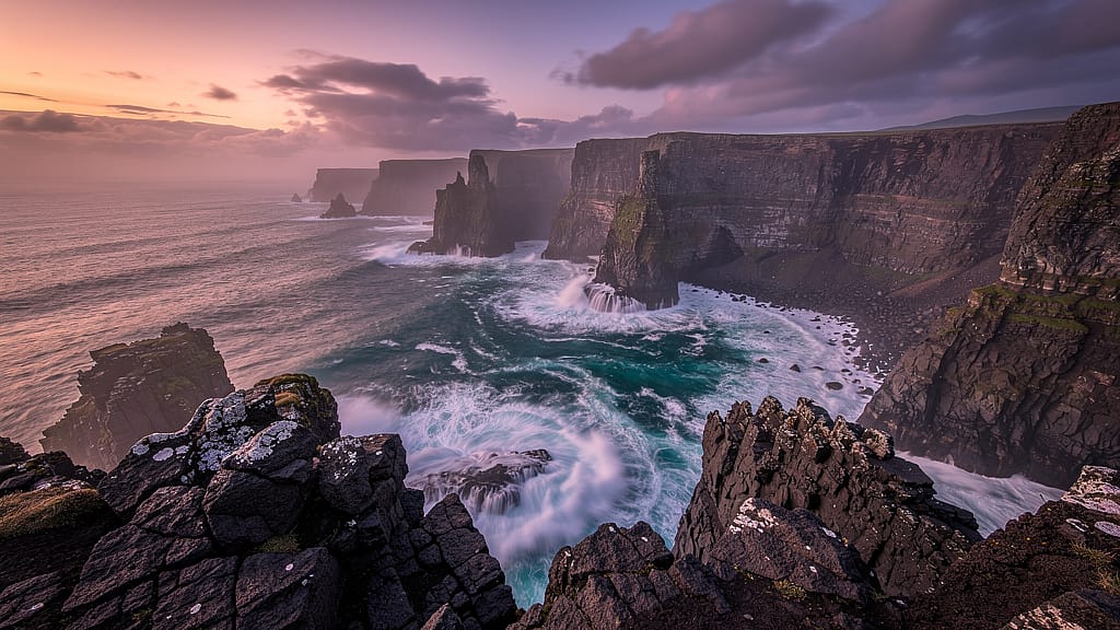 Coastal Cliffs at Dusk — Dramatic coastal cliffs at dusk, magenta and orange sky, smooth long-exposure turquoise wa
