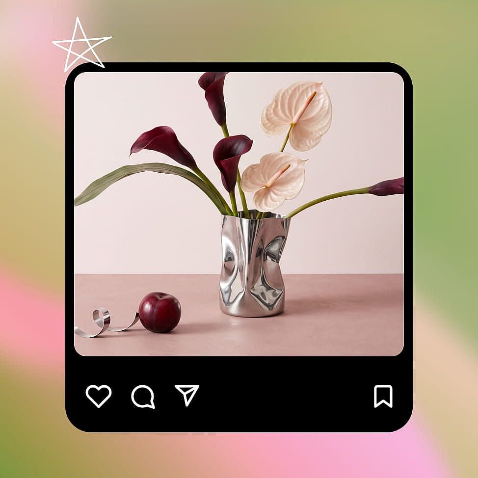 Floral still life with burgundy and blush flowers in a silver vase, displayed in a social media card with a save icon.