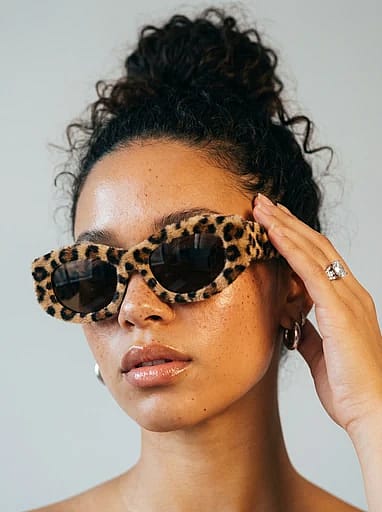High-end fashion editorial portrait with polished 90s aesthetic and soft bright studio lighting.