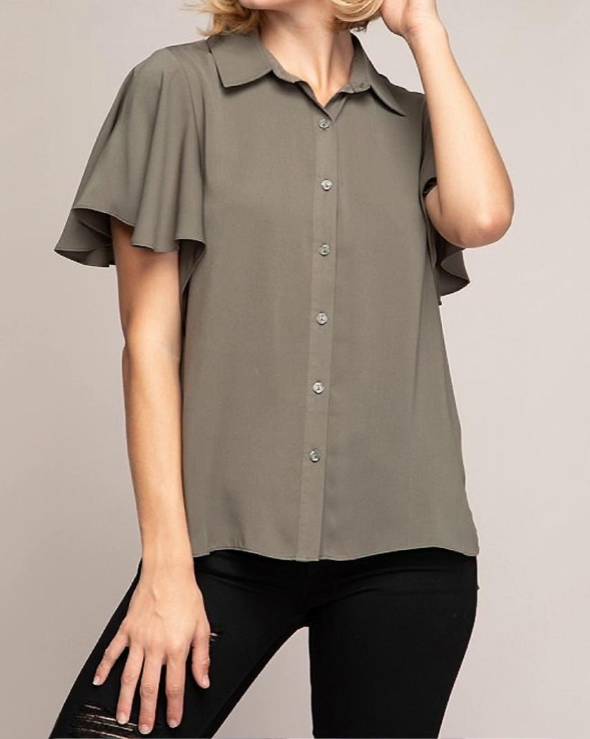 Prompt: a woman models a button up blouse with short fluttery sleeves. she moves naturally, slowly, side to side moving her arms to accent sleeves. as she spins left to show off the blouse the camera slowly orbits right. ratio 9:16