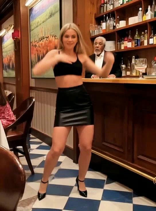 Prompt: The bartender helps her up onto the bar so she can continue to dance for the men