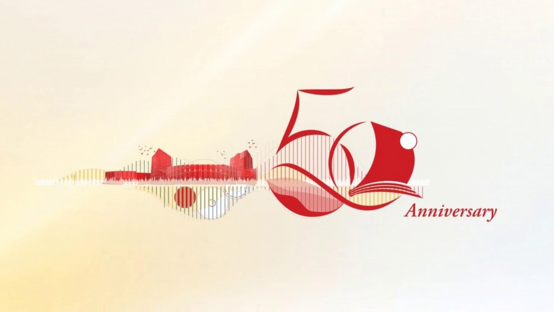 Prompt: Create a cinematic 3D animation based on this anniversary poster design. 
Keep the original composition: stylized red and orange cityscape on the left with reflective water surface below, vertical red and white light bars, flying bird silhouettes, and a large elegant “50 Anniversary” typography on the right.

Start with a soft golden sunrise glow and gradient background from warm yellow at bottom to white at top.
Animate the city buildings rising smoothly from the horizon with subtle light reflections on the water.
Vertical stripes slowly pulse upward like data streams.

Birds gently fly across the sky from left to right.

Camera slowly dolly moves from left cityscape toward the right side, revealing the 3D “50” logo forming with elegant ribbon-like motion.
The number “5” flows in a smooth curved stroke animation.
The “0” appears with a soft glowing outline and small white accent circle.

Animate the word “Anniversary” writing itself in red cursive handwriting style.

Add cinematic lighting, soft volumetric light rays, realistic shadows, glossy reflections, depth of field, floating particles and subtle glow effects.

Style: modern minimal corporate anniversary branding, premium, elegant, inspirational.
Motion: smooth, slow, luxury motion design.
Resolution: 4K ultra HD.
Duration: 8–12 seconds.
Aspect ratio: 16:9.
