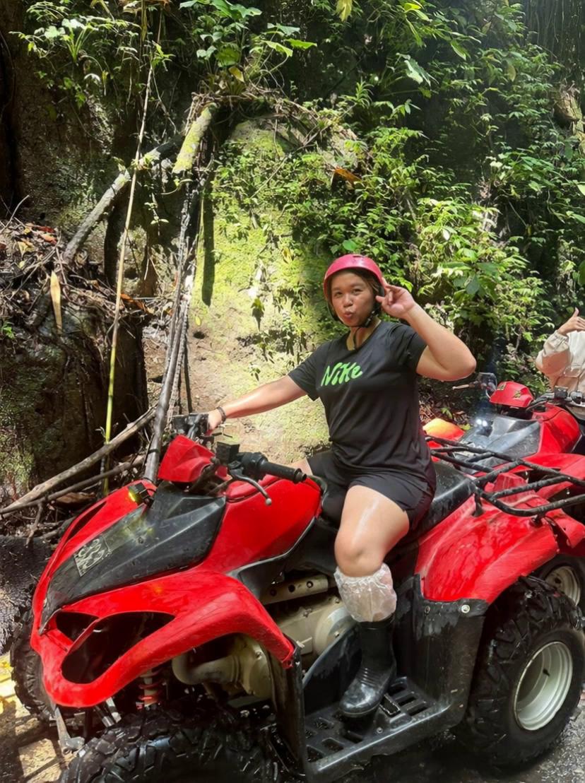 Prompt: A person tries to drift an ATV dramatically like in an action movie. The ATV spins too far and the rider falls off gently, rolling in sand while laughing. Funny, realistic, cinematic shot.