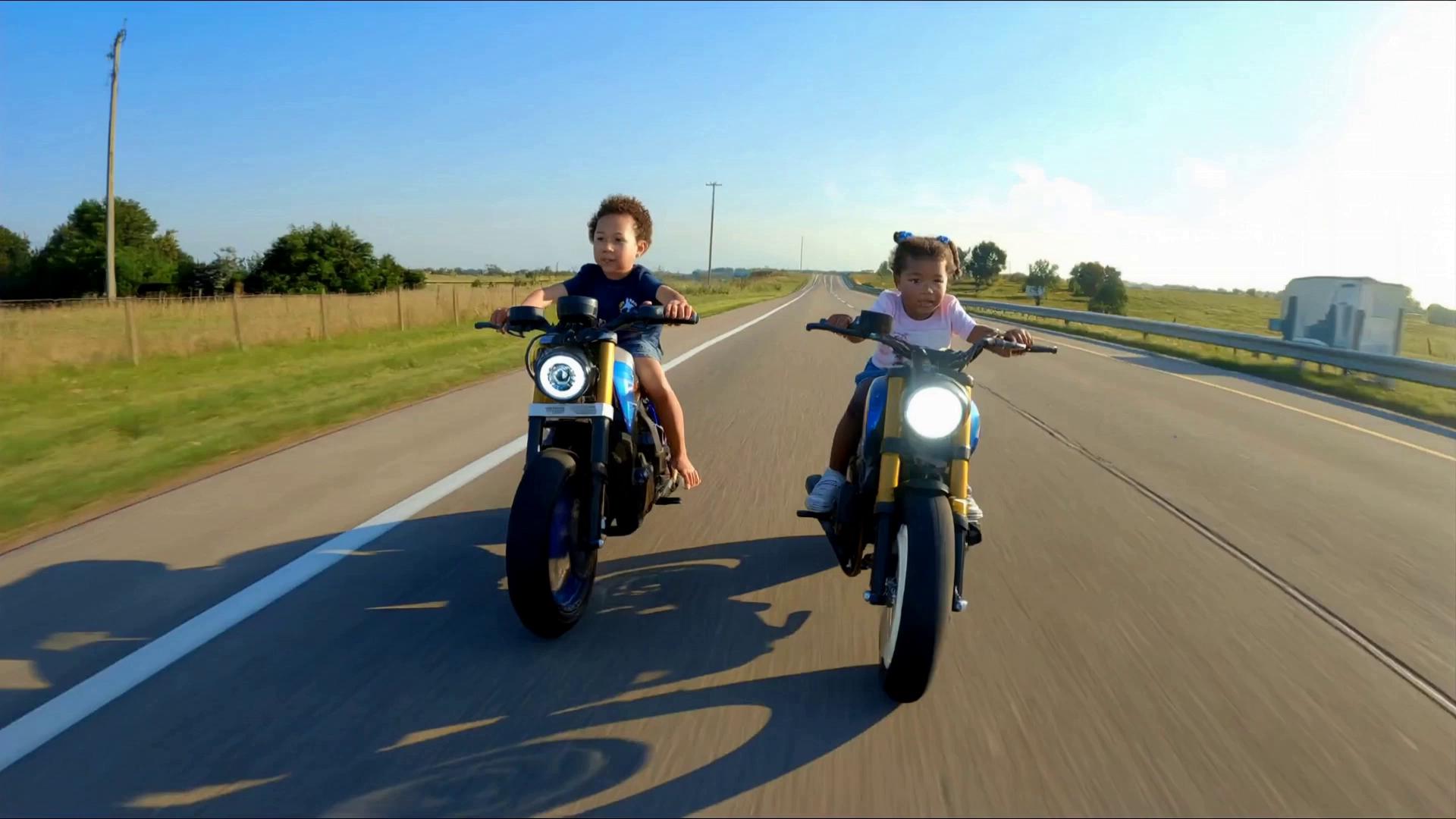 Prompt: Using the to images uploaded, Create a super ultra realistic action video of the two little boy and girl each riding their own super sport 1300 CC motorcycles. on a country back road highway. Camera Zooms in to get a close up of both of their faces, with a look of excitement on their faces as they ride competing against  one another.  And the girl suddenly accelerates past the boy widening the distance between them. Camera Zooms out.