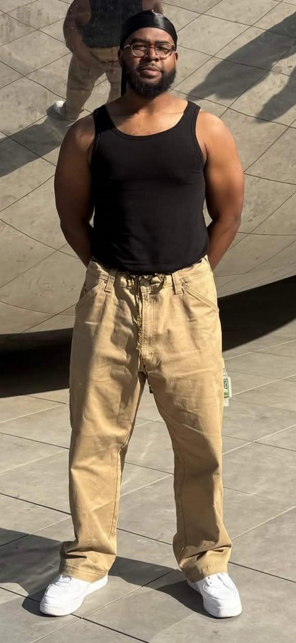 Prompt: Have this man posing for a photo, and then out of nowhere John Pork runs into frame and tackles him while screaming; "JUSTICE FOR DELMAR JERKINS". Have the man being tackled scream in fear. 