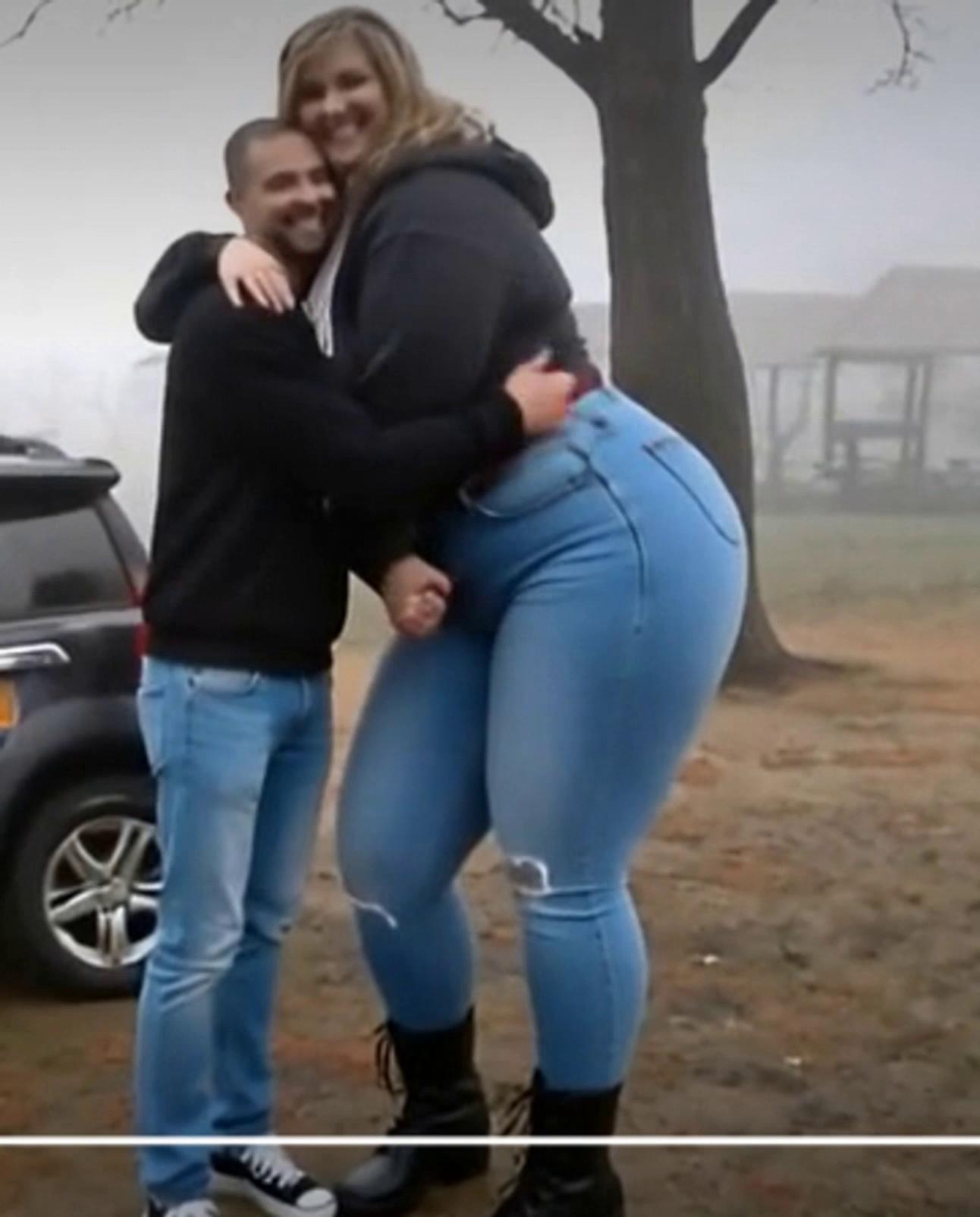 Prompt: a giant like woman who is very thick hugs her skinny  boyfriend abd lidts and spins him like hes  weughlless  she slips and falls forward topllinh him