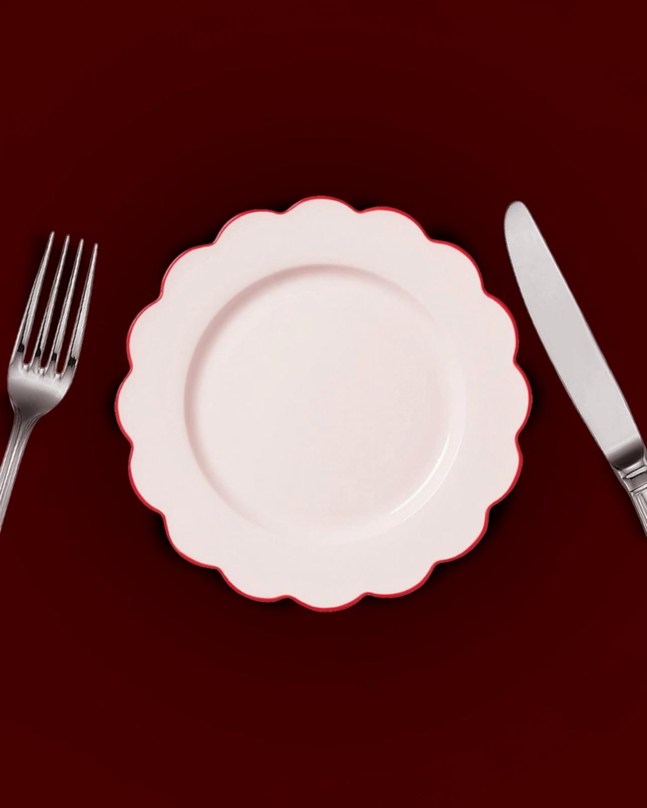 Prompt: Static top-down shot of a dinner table setting on a deep burgundy background.
At the center, a pale pink ceramic plate with a scalloped edge. A fork on the left and a knife on the right, perfectly aligned, stainless steel, classic style.

The scene remains completely static and symmetrical.

A single white-gloved hand (formal, elegant, cotton glove) slowly enters the frame from the top of the image. The movement is smooth, calm and deliberate.

The hand gently places a cream-colored invitation card on top of the plate. The card is slightly angled, centered, and reads “2026” in large serif typography, with a small handwritten-style text below saying “you’re invited”.

After placing the card, the hand slowly exits the frame, leaving the final composition perfectly still.

Cinematic lighting, soft shadows, realistic textures.
Minimal movement, no camera motion.
Editorial, refined, festive but restrained atmosphere.
High realism, high quality.
