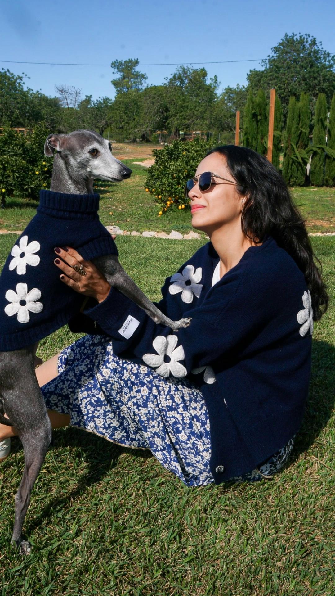 Prompt: a girl playing with a dog wearing matching outfit as in the image. 