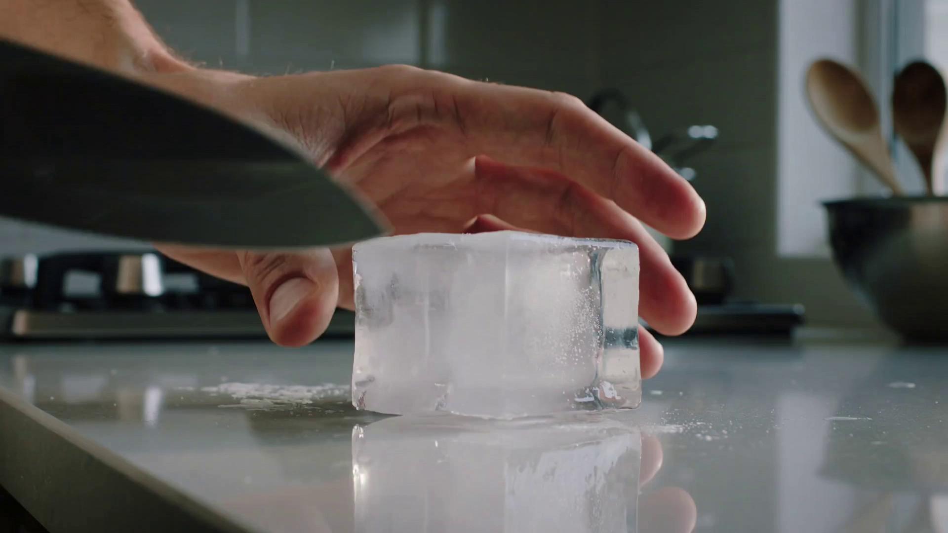 Prompt: Cutting an ice cube with the knife