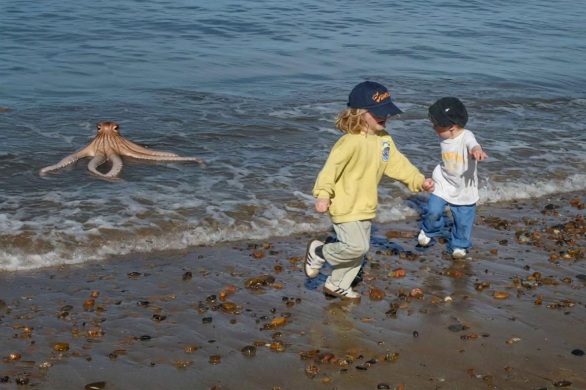 Prompt: octopus splashing water with 8 legs, stands up and starts chasing the boys up the beach, boys panic and running frantically waving,, waves rolling in, 