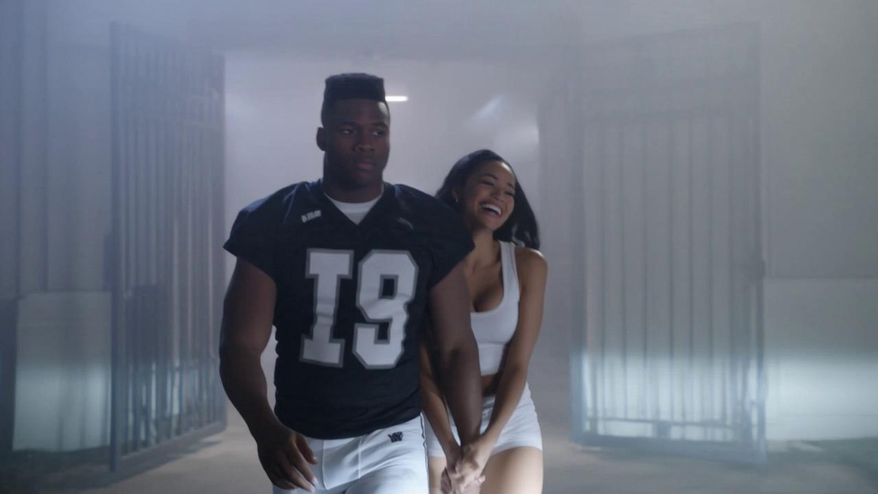 Prompt: Upgraded Clip 8: "The Dark Room Staredown" (1:45 – 2:00)Visual (Second-by-Second Beats):(1:45–1:49) The Stolen Crown: Nathan, Nathan Wilson, a tall 6'5 broad-shouldered 18-year-old African American quarterback, muscular 250lbs athletic build, razor-sharp jawline, intense focused eyes, fade haircut, steps out of the stadium back exit into humid Mississippi fog. Walking right beside him—her fingers laced tightly through his is J.T.’s ex-girlfriend, laughing as she tosses her Saint Jude VIP pass aside. Nathan slides her into the passenger seat of his new sports car and then walks around to the driver's side of the car.  The Predators Above: Nathan pauses before entering the car, his spatial awareness triggering. He looks straight up toward the high-altitude Executive Suite. High-angle zoom reveals the dark silhouettes of Judge Cole, Dr. Evelyn Vance, and Julian Sr. staring down behind tinted glass. On Evelyn's console screen, a digital red target box locks onto Nathan. Nathan locks eyes with the suite, smirk fading into an ice-cold glare, before stepping into the driver's seat.The Boiling Point: From behind the stadium gates, J.T. watches the taillights glow, his jaw clenched so hard his teeth grind, realizing he just lost his starting role, his status, and his girl to the freshman phenom in a single night.(1:54–2:00) Audio / SFX:Car door heavy thud $\rightarrow$ sports car engine roar $\rightarrow$ high-frequency electric ring $\rightarrow$ deep hollow sub-bass THUD $\rightarrow$ hard cut to silence.Voiceover / Text on Screen:Nathan (VO): "In Magnolia Bay, when you take everything a man owns... they don't just hate you. They plot your execution."On-Screen Text: To Be Continued (Glows blood-red $\rightarrow$ Cuts to black)