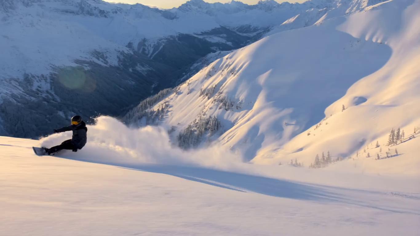 Prompt: Epic cinematic snowboard footage — pro rider carving through deep powder 
with snow spraying, dramatic mountain backdrop, golden hour lighting, 
slow motion, 4K quality. Could also use existing stock footage or 
your own clips.
