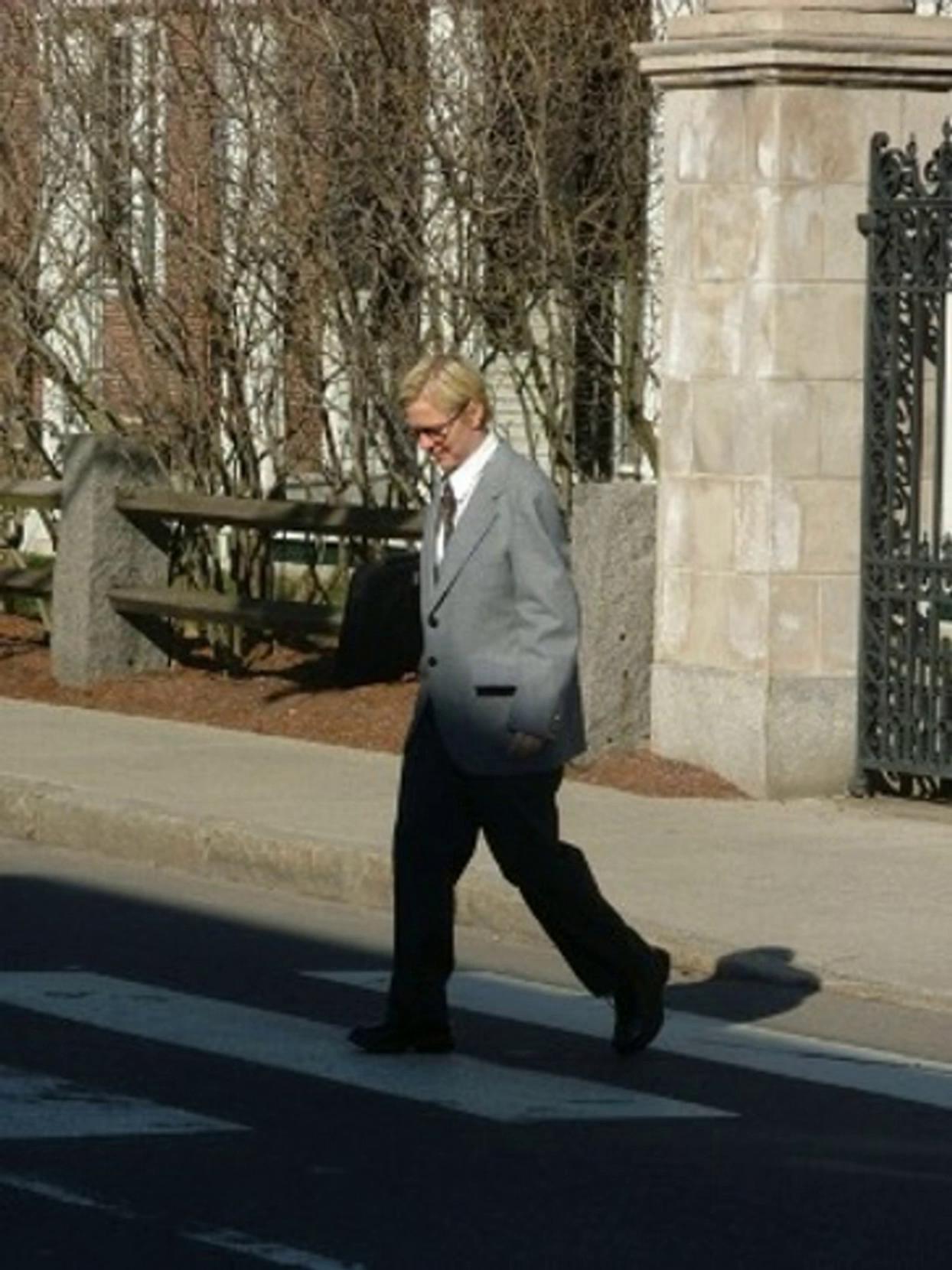 Prompt: Dr Jacobs is deep in thought while crossing a street