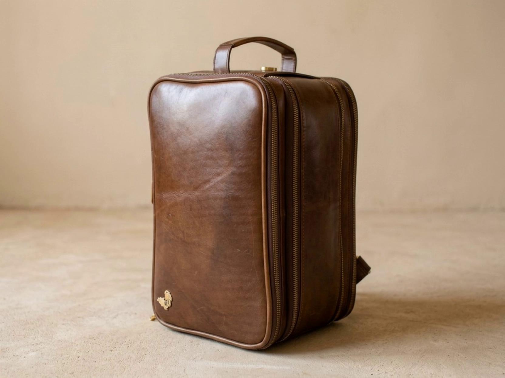 Prompt: Create a professional video showcasing a [color] [style] toilet bag. The video will be a seamless sequence of four slow-motion shots:1. Angle 1 (Front View): A slow pan across the front face, highlighting the leather texture and the main zipper details.2. Angle 2 (Top/Logo View): A slow dolly-in close-up from above, revealing the branded logo in detail.3. Angle 3 (Side View): A slow orbit from the side, showing the bag's profile and side zipper.4. Angle 4 (Rear/Pockets): A slow pan across the back, showcasing the rear pocket/compartment details.Transitions: Each clip should transition into the next using a slow, elegant cross-dissolve or crossfade lasting 1 to 1.5 seconds to create a dramatic and luxurious feel.The overall video should be around 10-12 seconds long. The setting should be a minimalist, well-lit studio. The mood is premium, detailed, and cinematic. Pacing: slow and deliberate. –no fast cuts, no jarring transitions, no background clutter. The video frame should fit perfectly on Instagram without leaving any space on the side.