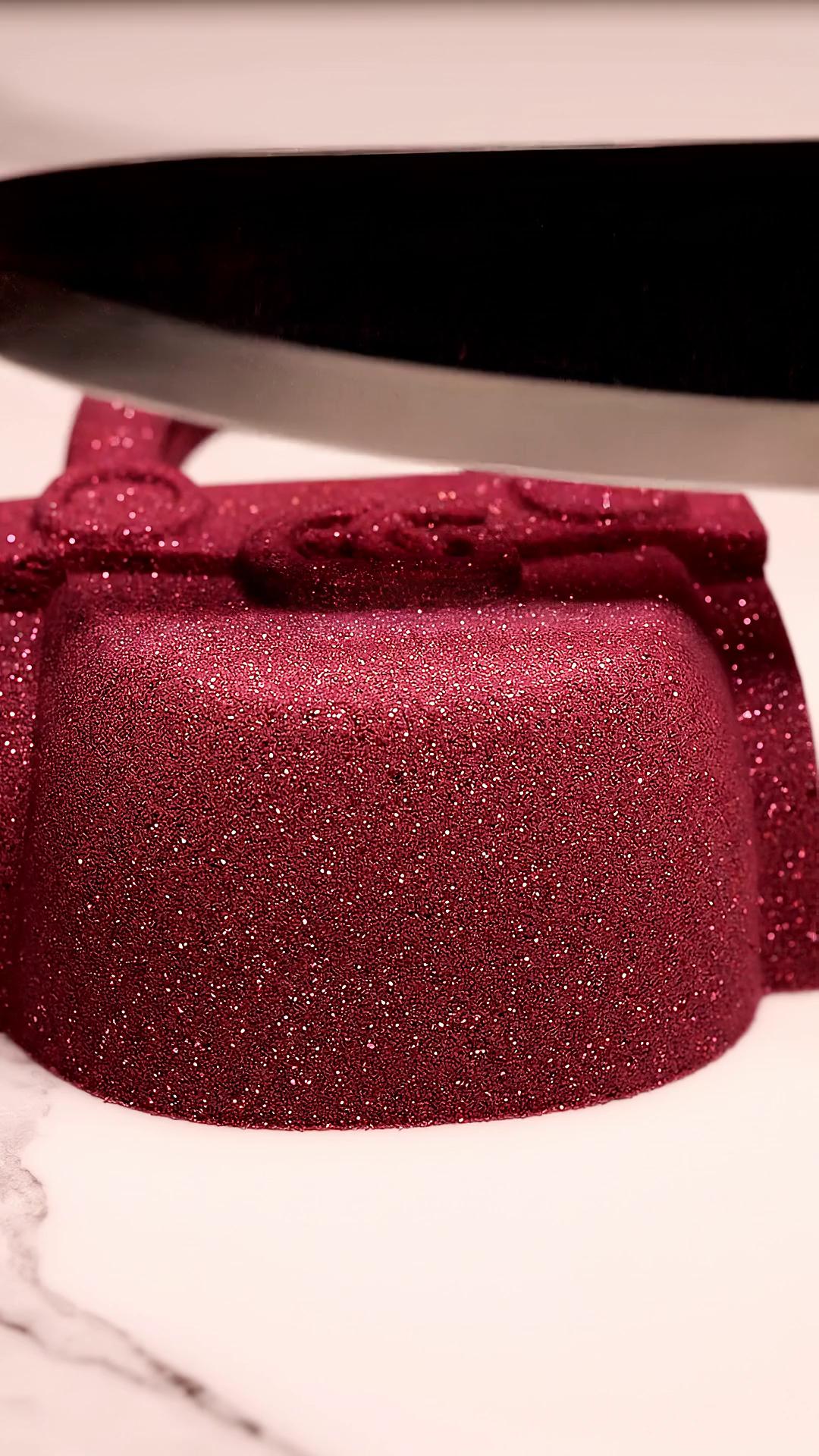 Prompt: "Perfectly shaped kinetic sand molded into a luxury handbag silhouette on a marble background. Slow, precise knife slicing through the sand creating symmetrical cuts. Clean crumble effect, soft satisfying sound, cinematic macro shot, high-end aesthetic, warm soft lighting, minimalistic background, seamless loop reset."
