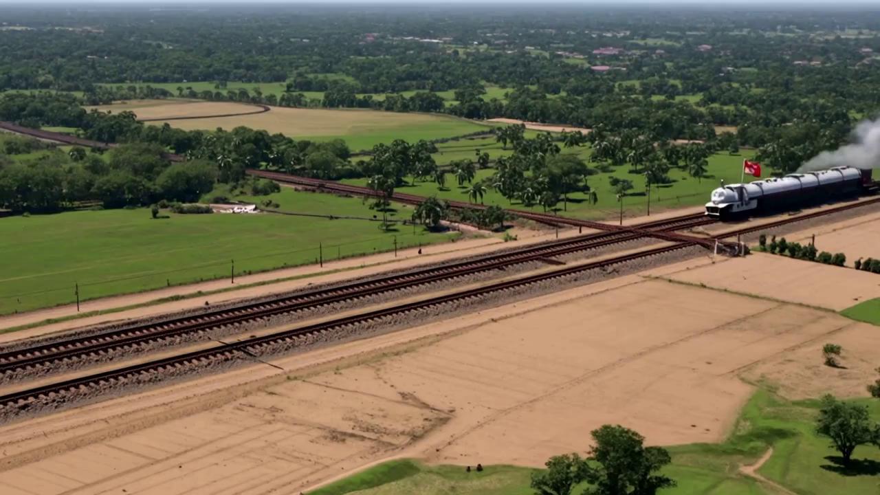 Prompt: "A cinematic 3D animation starting with a vast view of colonial-era India, dusty railway tracks cutting through lush fields. A steam train with the British flag rushes past poor Indian villagers working on the tracks in the heat. Cut to British officers in crisp uniforms overseeing cargo being loaded—cotton, spices, gold—onto the train at a colonial port. Shift to a map animation showing rail lines radiating out from British trade cities like Bombay and Calcutta. Then, a quick montage of soldiers boarding trains, suppressing protests, followed by Indian freedom fighters secretly using the same trains to organize resistance. End with a powerful contrast: a modern Indian train with the national flag soaring through the same land, fading into the question, 'Was it built for India… or for Empire?' Text overlays, dramatic lighting, and intense background music throughout."