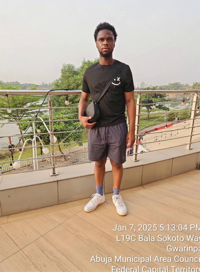 Prompt: A man walking slowly away from the rail of a shopping mall.