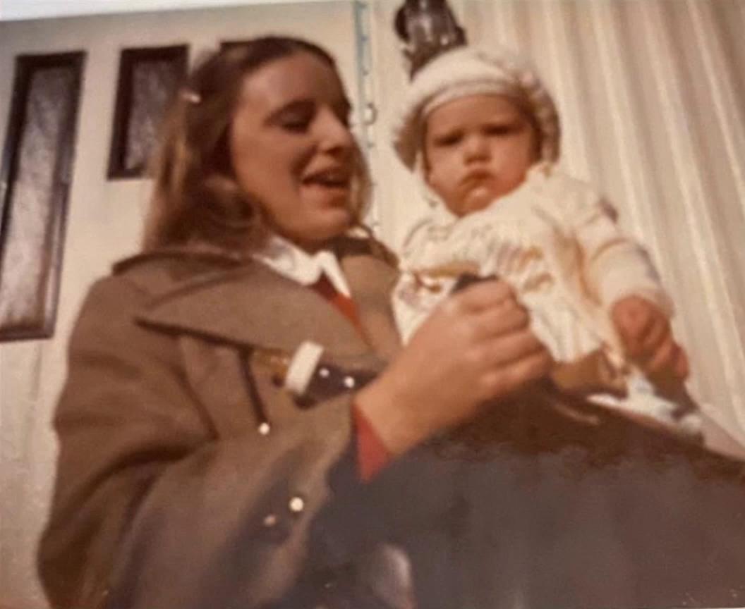 Prompt: Younge mother lovingly holding her baby. Mother is telling the baby she loves her so much.