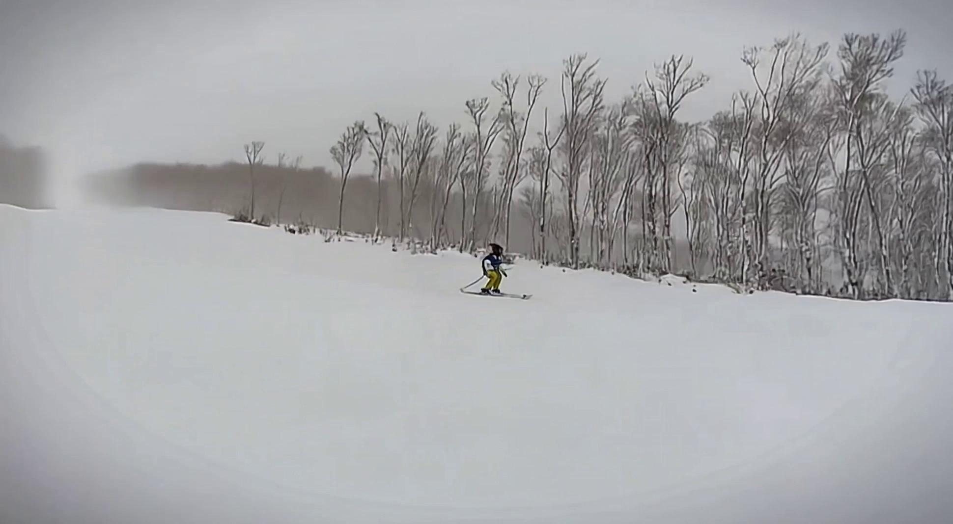 Prompt: there are some stains on the camera when filming this video, please remove the stains and make the video clearer. Remember the focus of the video is the man skiing and the background landscape, please preseve them to the extent possible.