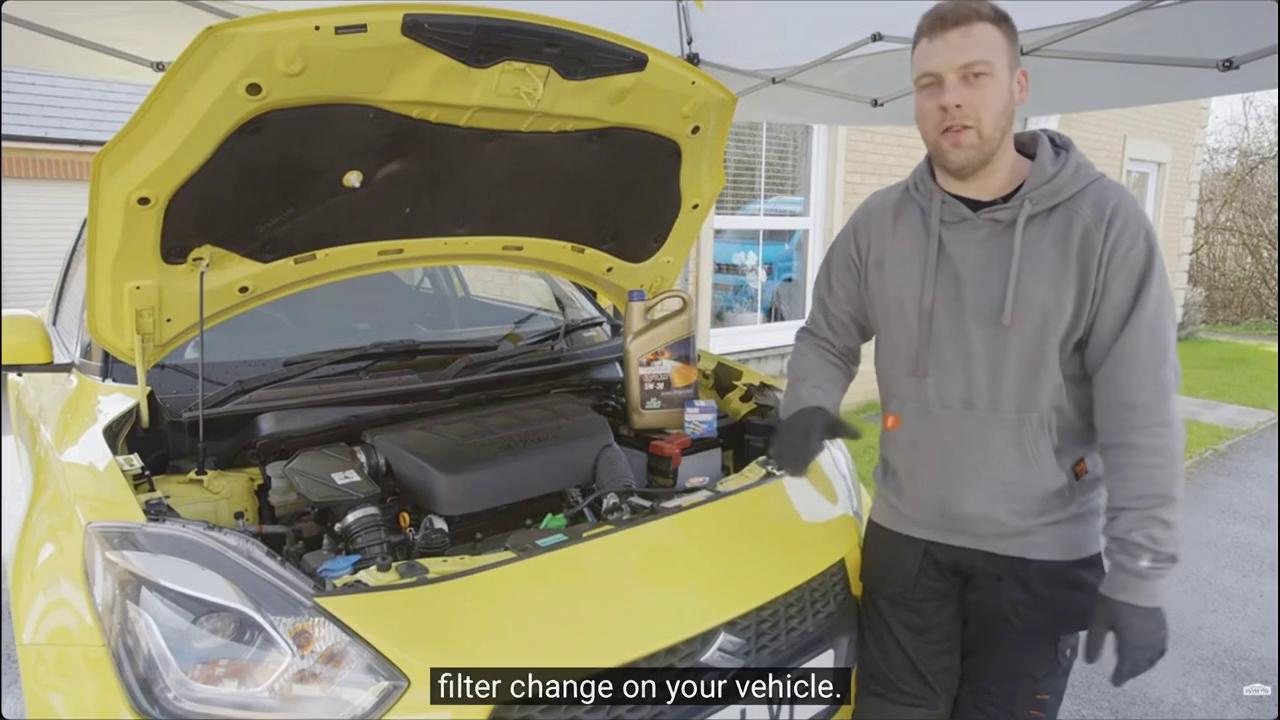 Prompt: 
Car oil service process on private driveway in Ireland.
