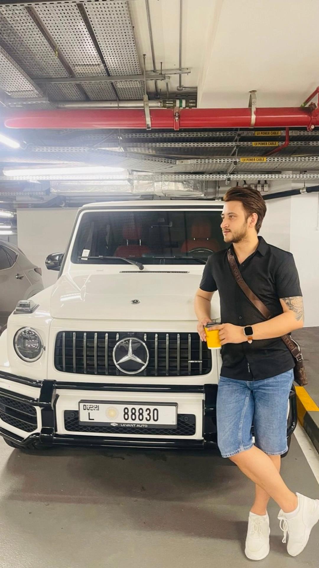 Prompt: Man gets into the car opens the door starts the engine and flash the headlights