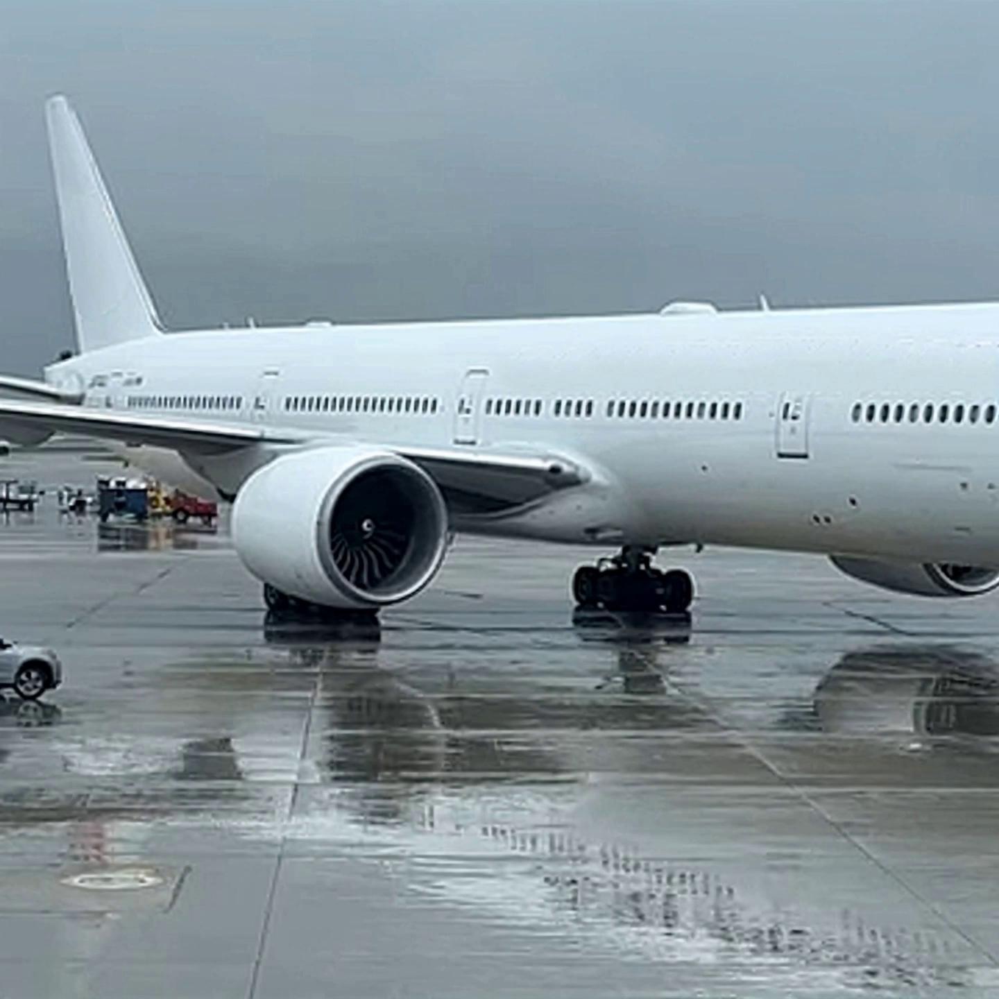Prompt: the airplane itself is taxiing backwards with a help of another vehicle, beginning to depart