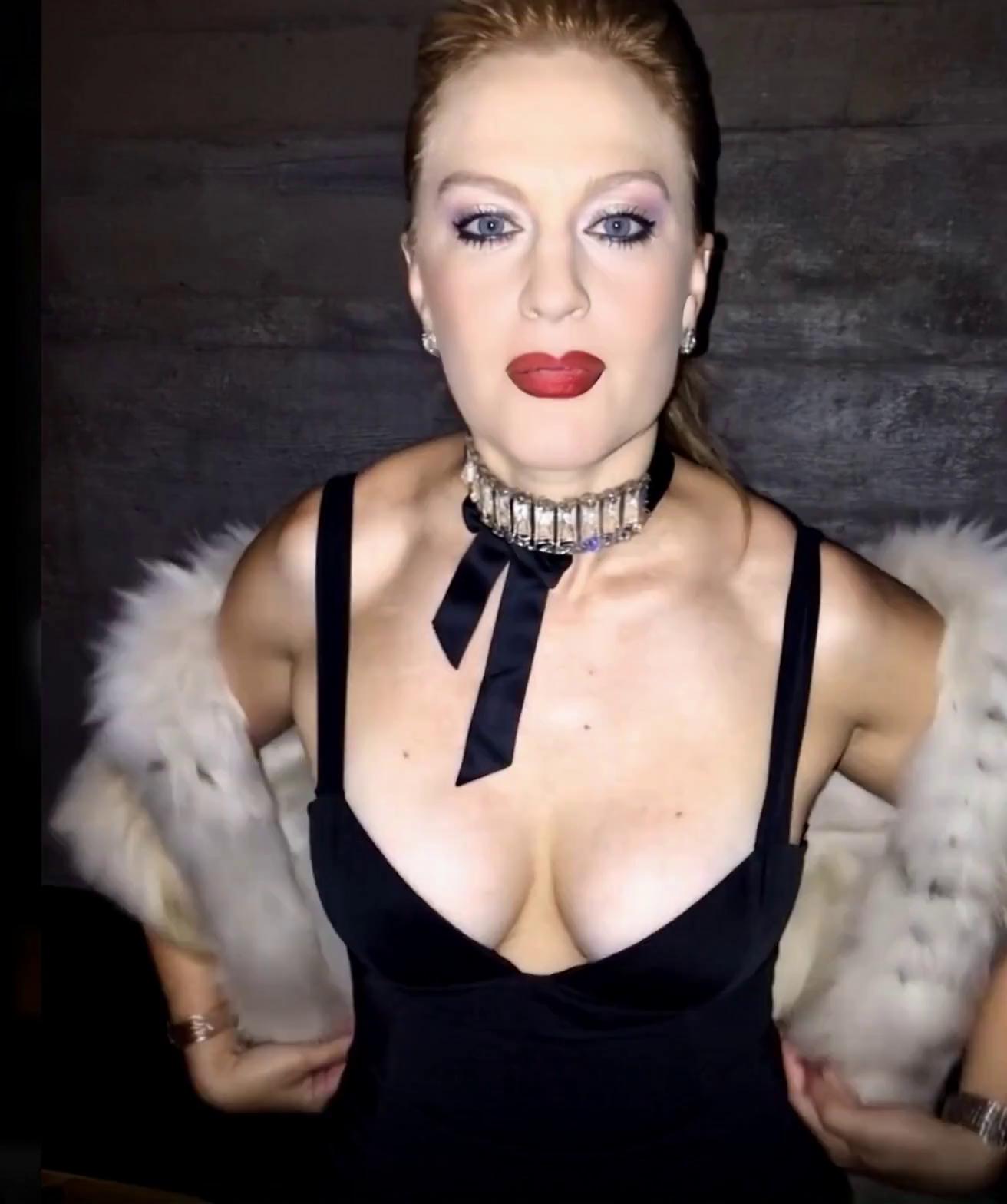 Prompt: She drops the fur off her shoulders. Her dress comes down... She pushes her chest out.