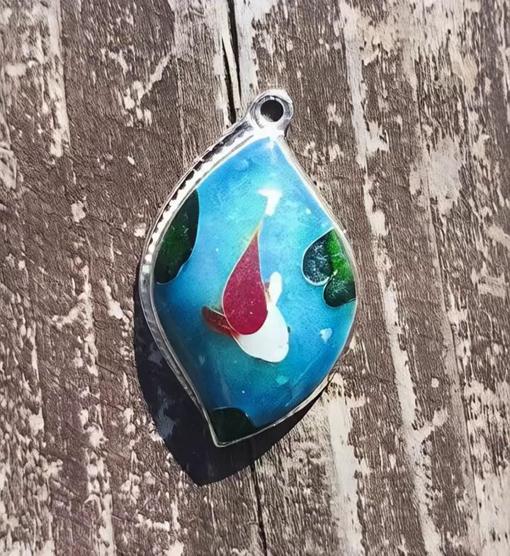 Prompt: Make sheets and water in pendant move inside the pendant slowly and down 