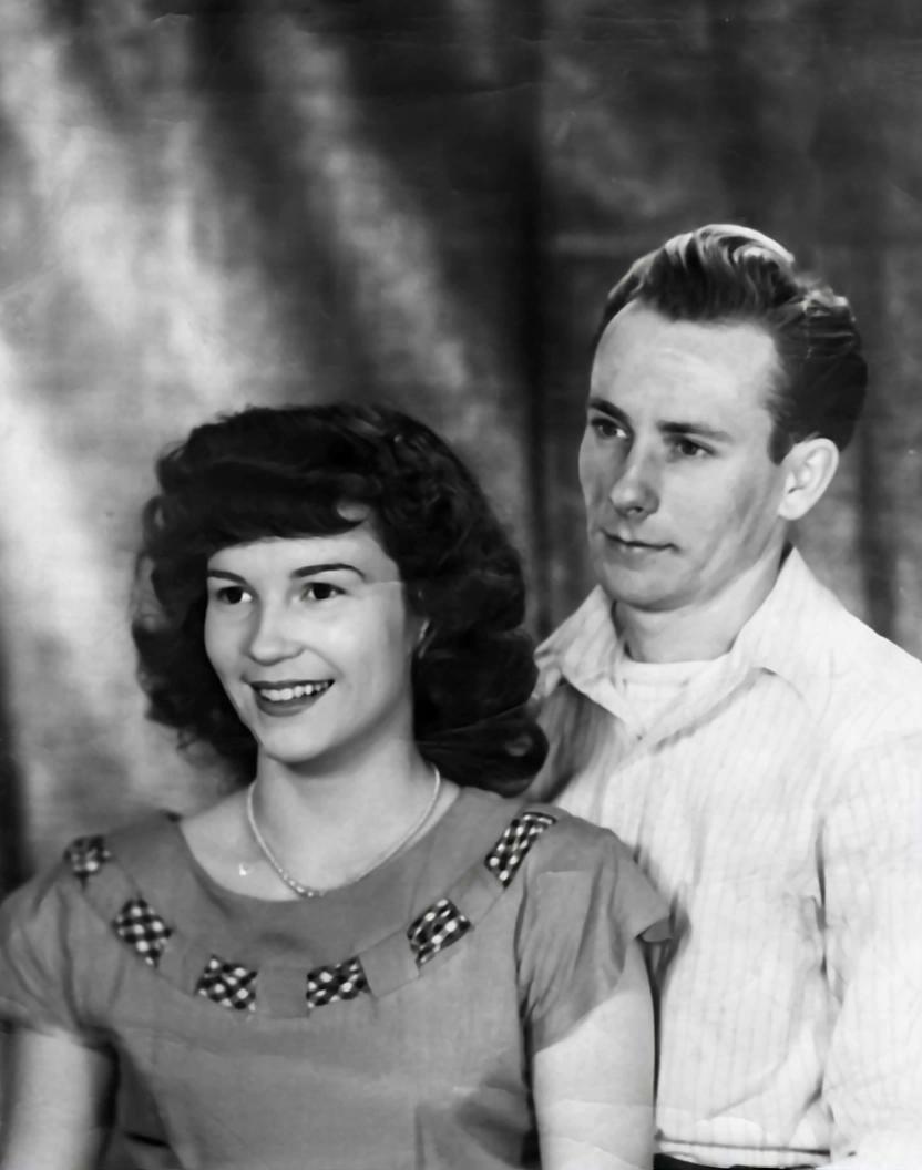Prompt: A man and woman posing for a picture and then hugging
