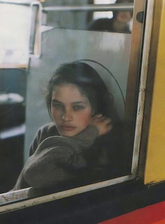 Prompt: A cinematic shot of a young person, based on the uploaded model reference photo, sitting alone on a dimly lit bus at night, scrolling aimlessly on their phone through TikTok or YouTube Reels. The bus is moving, city lights blur past the windows, creating a dreamy atmosphere. The character looks isolated, absorbed in the glowing phone screen, while other passengers appear blurred, emphasizing the feeling of disconnection. The mood is introspective, moody, and slightly melancholic, like time is slipping away unnoticed.