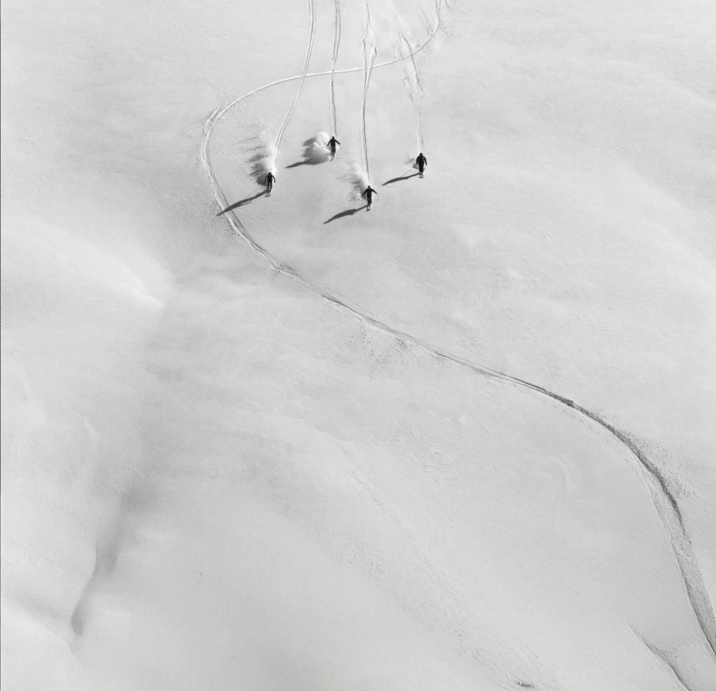 Prompt: professional freeride skiers skiing down the mountain in a straight line