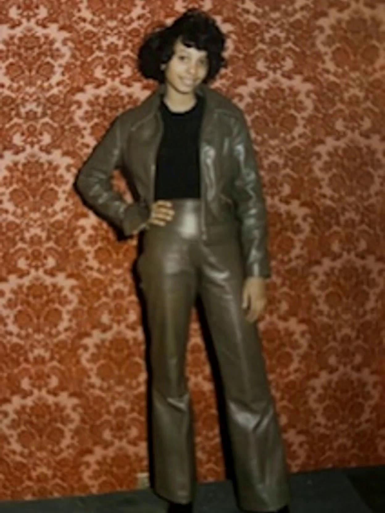 Prompt: Posing in her leather suit, Nisey is the star of the party.