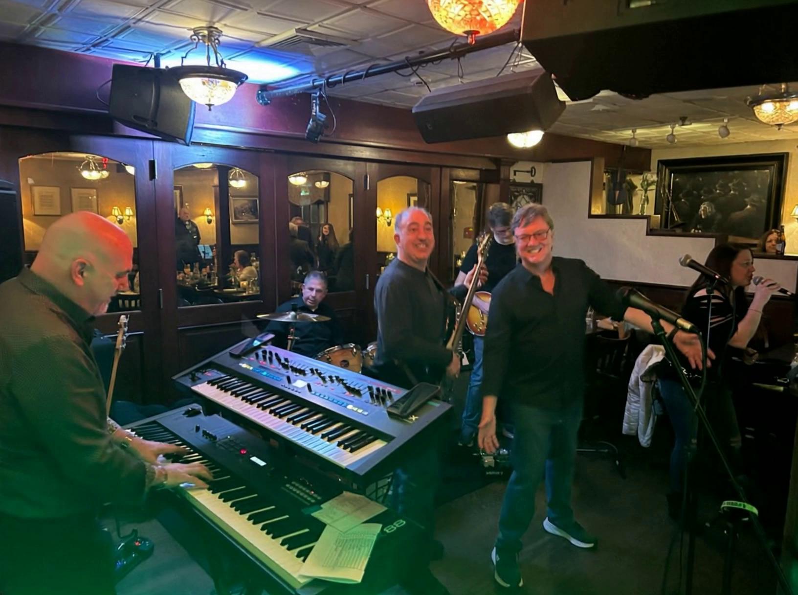 Prompt: Lead singer appears in group photo