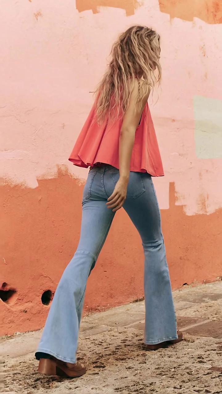 Prompt: The words "Free People" painted on the wall behind the model