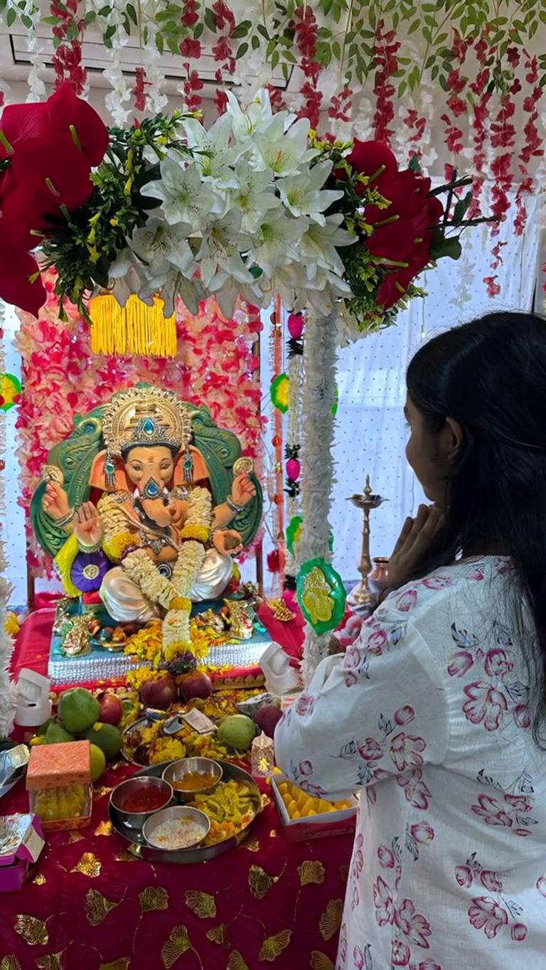 Prompt: Make Lord Ganesha
take a couple of steps forward, then stand up and hug the girl in front of him like a father lovingly hugging his daughter. The hug should be around her neck/shoulder area (not the face), and his trunk should also move naturally as if he is alive