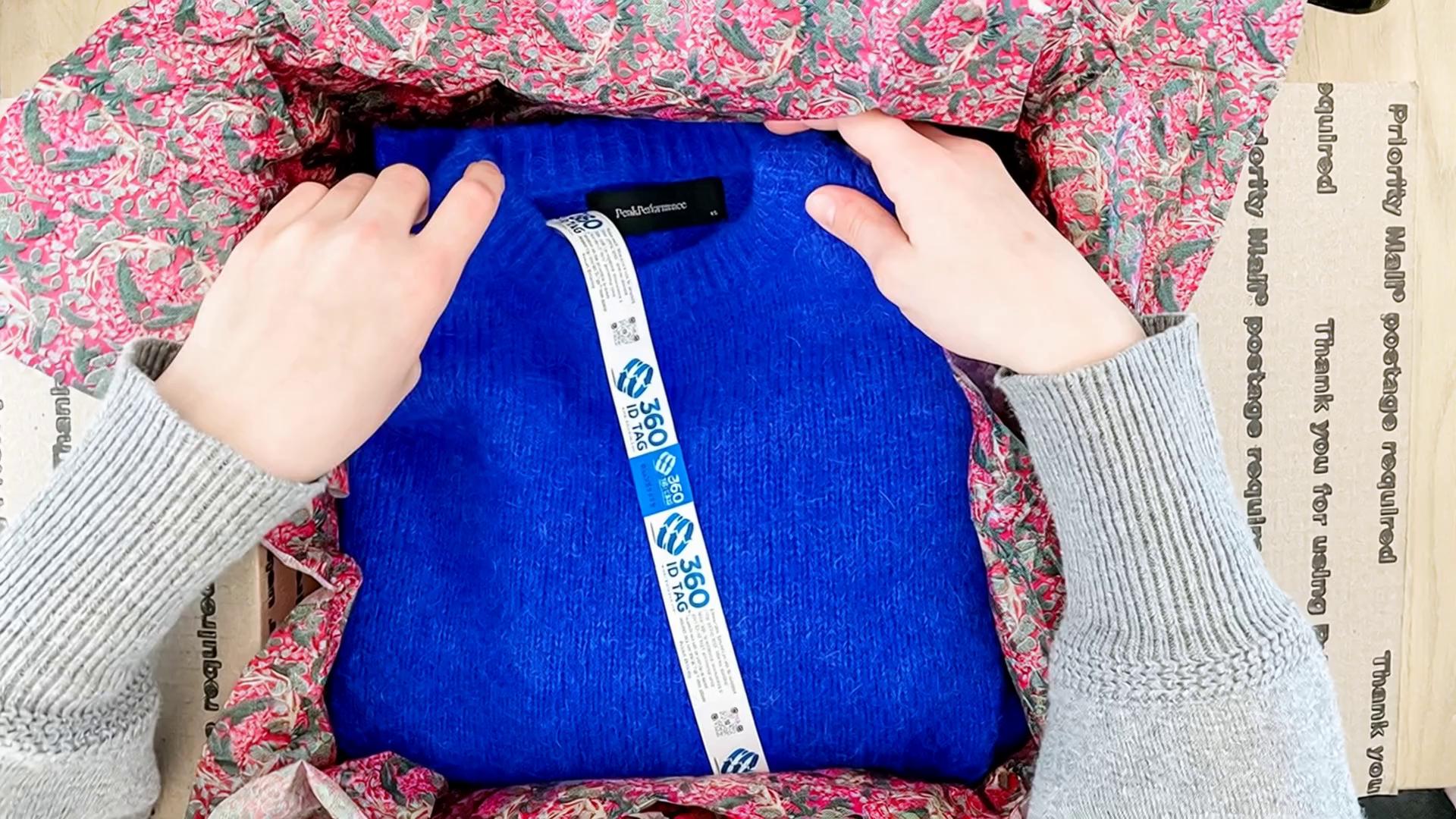 Prompt: lift the sweater out of the box