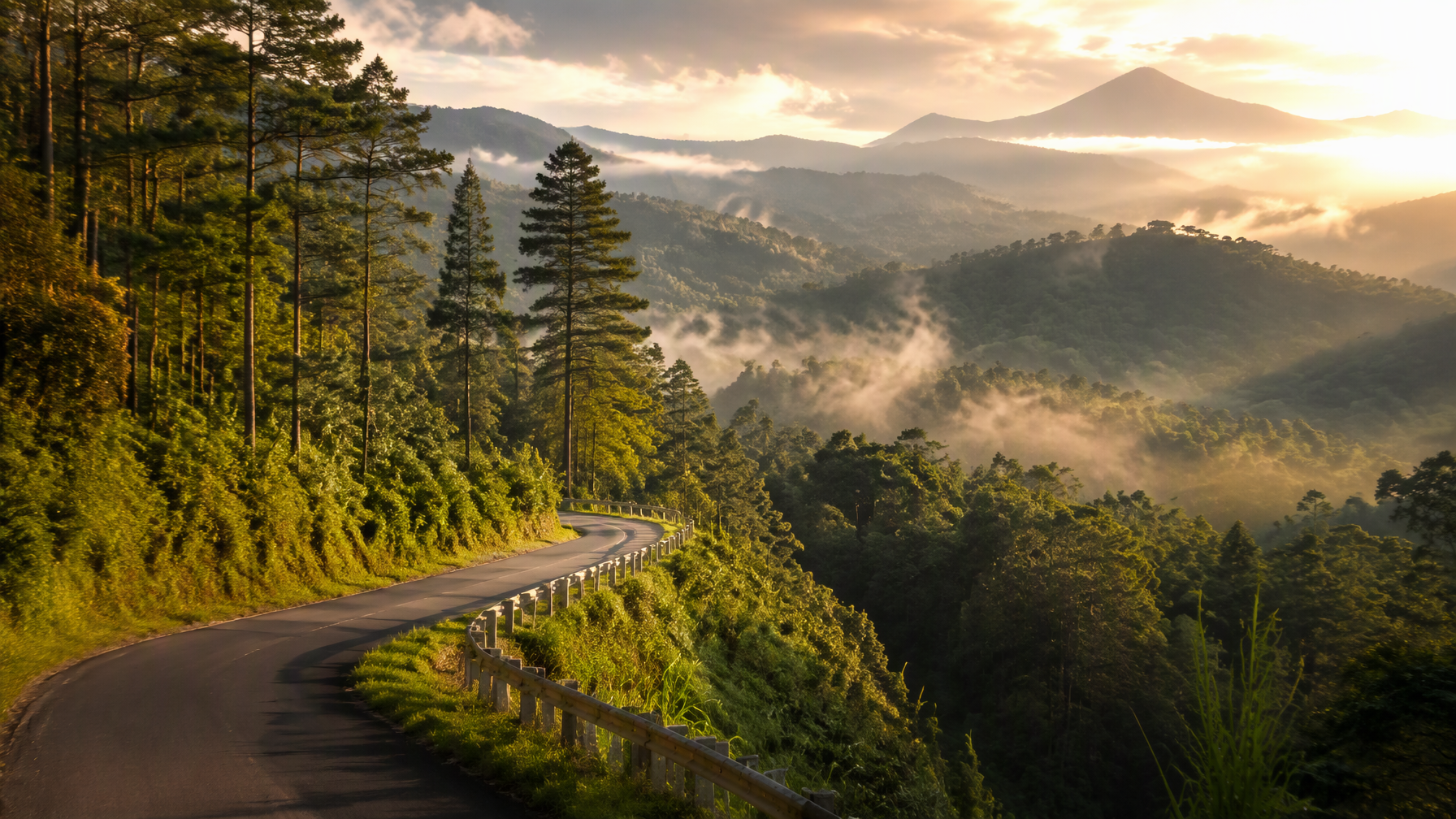 A stunning wide landscape photo of a winding mountain road to Baturraden with lush green pine trees