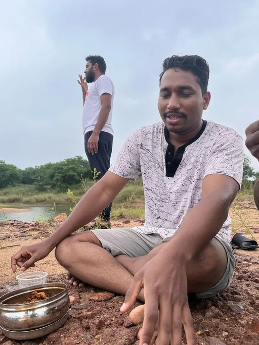 Prompt: a man sitting on the ground with a bowl of food in front of him and another man standing behind him, Bholekar Srihari, samikshavad, jayison devadas, a picture