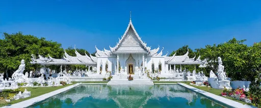 Prompt: Wat Rong Khun, Chiang Rai, Northern Thailand, Thailand

Wat Rong Khun, known as the White Temple, is located 13 km from the center of Chiang Rai. This modern Buddhist temple was designed and built by artist Chalemchai Kositpipat and opened to visitors in 1997. The temple impresses with its unique architecture, white color and many mirror elements symbolizing purity and spiritual enlightenment.

Inside the temple, you can see impressive paintings and sculptures that reflect Buddhist teachings and modern culture. The best time to visit is in the morning or evening, when the light highlights the beauty of the temple. You can get to Wat Rong Khun by taxi or bus from Chiang Rai.