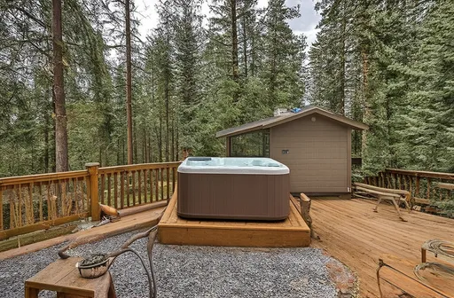 Prompt: (rambler home), single story, nestled in (lush evergreen forest), cozy deck with hot tub, overlooking a serene glen, warm color scheme, inviting atmosphere, tranquil vibes, high-quality details, ultra-detailed, perfect for real estate ads, showcasing natural surroundings, peaceful living, charming escape, harmonious integration with nature.