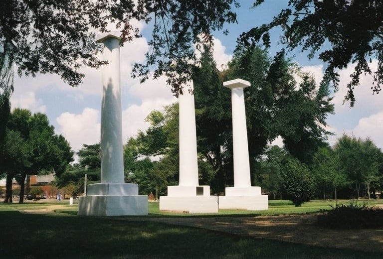 Prompt: Three columns from the old Bullard Mansion  tree on Northwestern State University, campus in Natchitoches, Louisiana