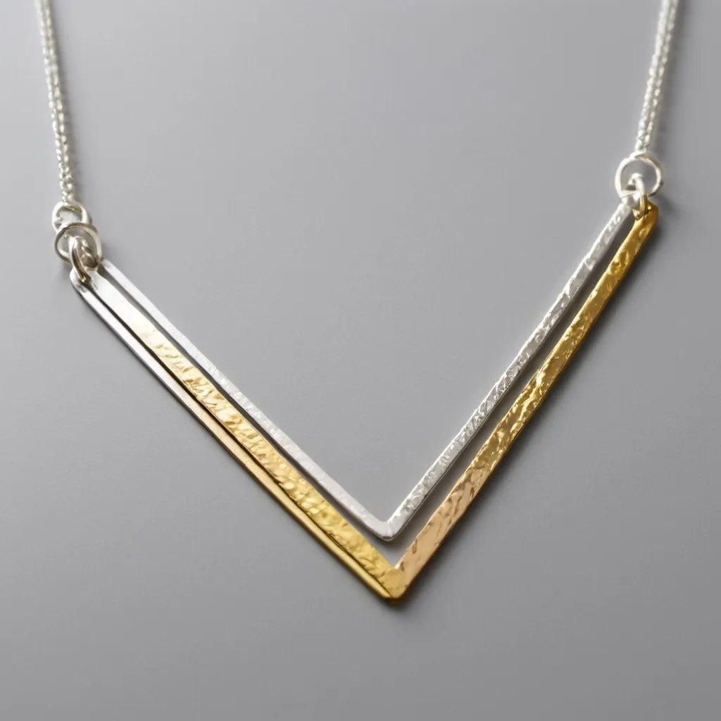 Prompt: a simple necklace made from small straight strips of precious metal some gold some silver