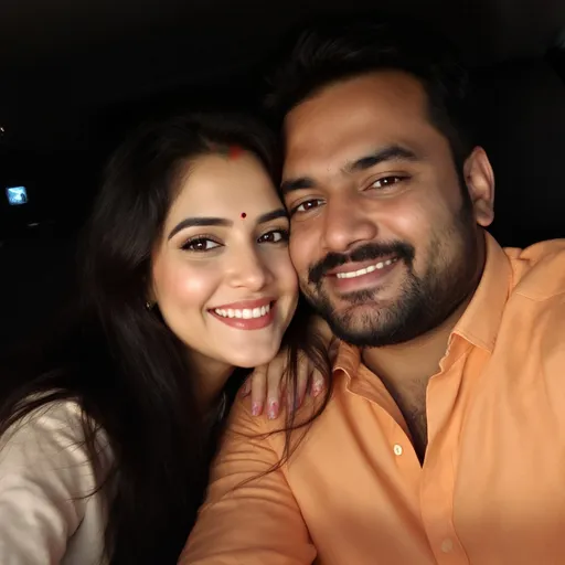 Prompt: A warm and intimate moment unfolds between a couple sharing a selfie, their faces closely framed and radiating joy. The woman, featuring long dark hair and a gentle smile highlighted by a small decorative bindi on her forehead, leans in while resting her head on the man's shoulder, who wears a relaxed and affectionate expression, adorned in a light orange shirt. The background suggests a cozy indoor setting, possibly within a car, with dark, partially obscured elements that add a layer of intimacy to the image. The soft lighting enhances the warmth of the scene, creating an inviting atmosphere filled with connection and affection. This snapshot captures a cherished moment between them, emphasizing their closeness and happiness.