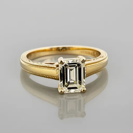 Prompt: A solitaire emerald cut ring.
Yellow gold.
Miligrain.