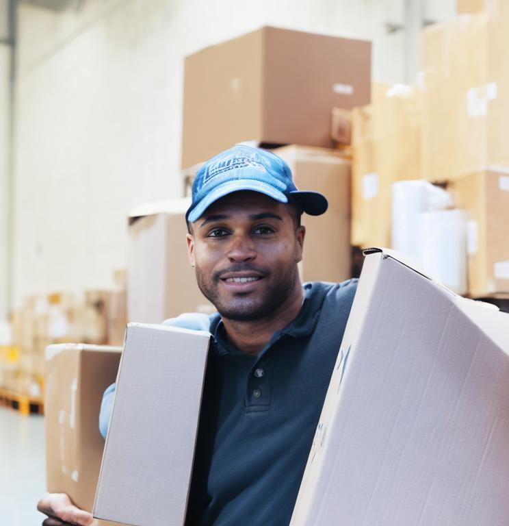 Prompt: warehouse full of boxes and trucks