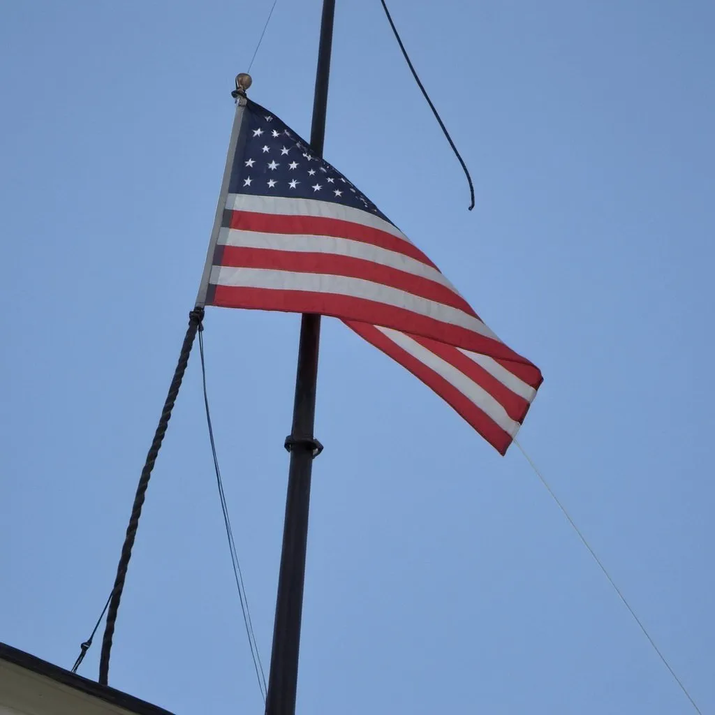 Prompt: Flag at 1/4 mast and in dire distress true to this all emergencies.