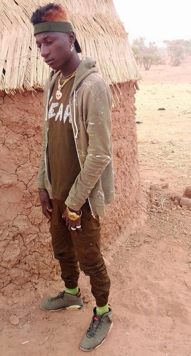 Prompt: Can you find photos of Ali Boubacar that show what life was like in an African village long ago?"