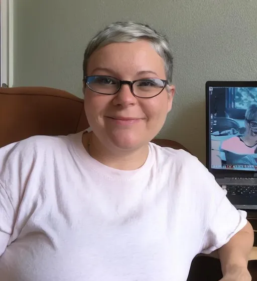 Prompt: Try to paint me like in the photo, I have short hair, I wear jeans and this, I wear glasses. I am a 50-year-old woman, but I look at least 30. Please paint me sitting in front of an HP laptop in my room, on a sofa, with a 15-inch laptop screen.